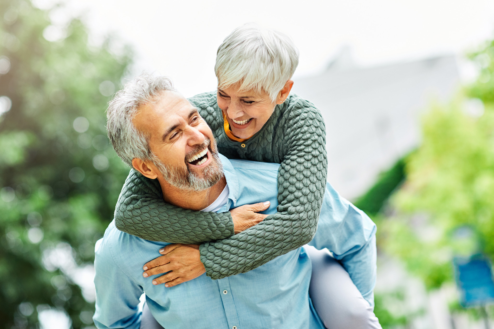 AdobeStock_514774108 v3 Older couple laughing outside, happy with their new cosmetic smiles in St Charles IL