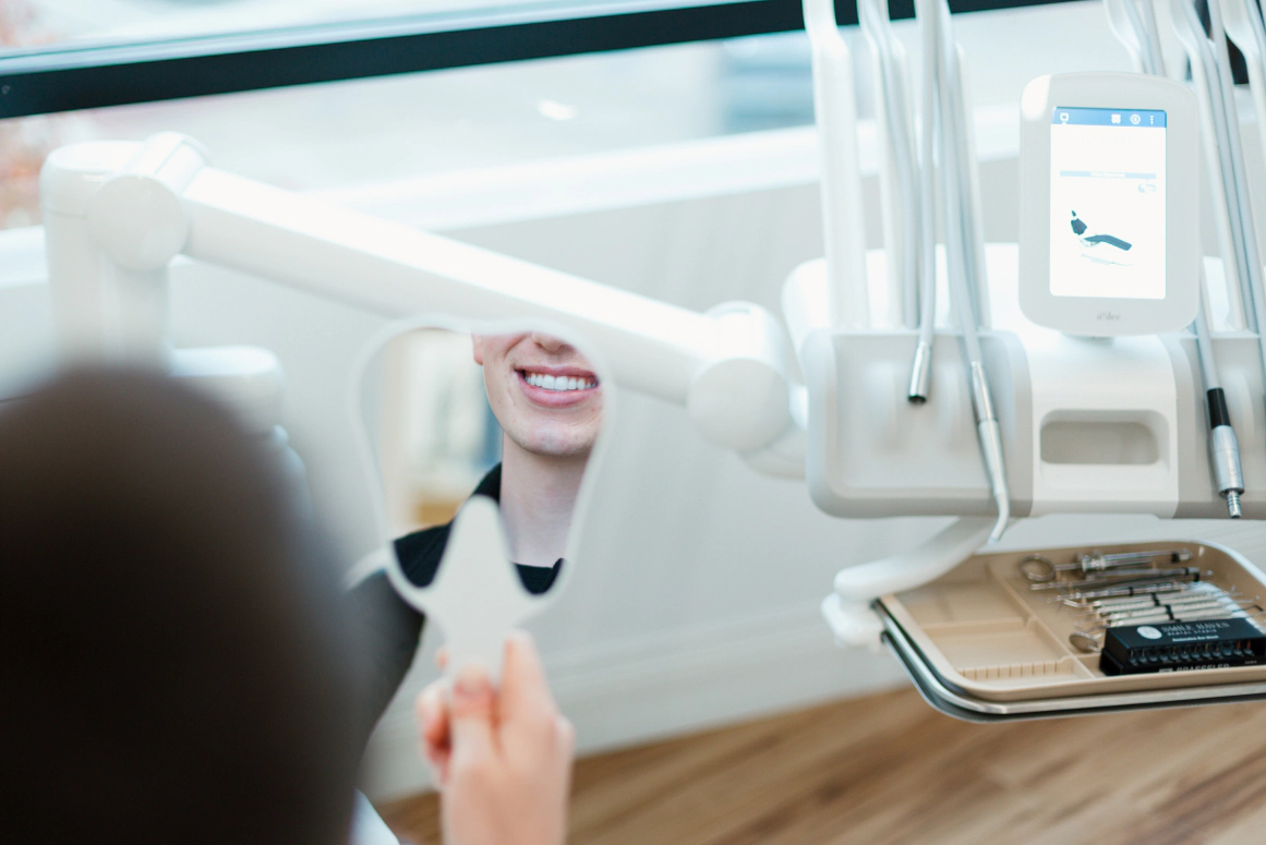 Older couple laughing outside, happy with their new cosmetic smiles in St Charles IL