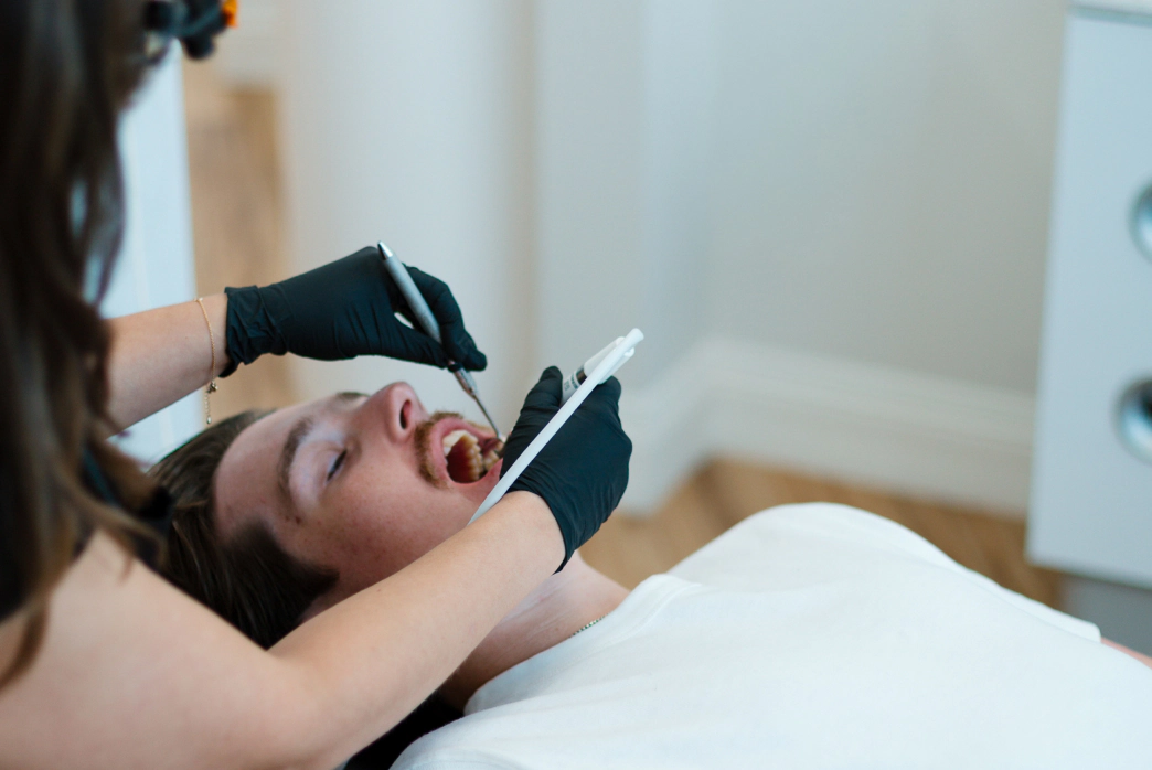 Man and woman showing off their confiedent smiles with cosmetic dental care at Smile Haven Dental Studio